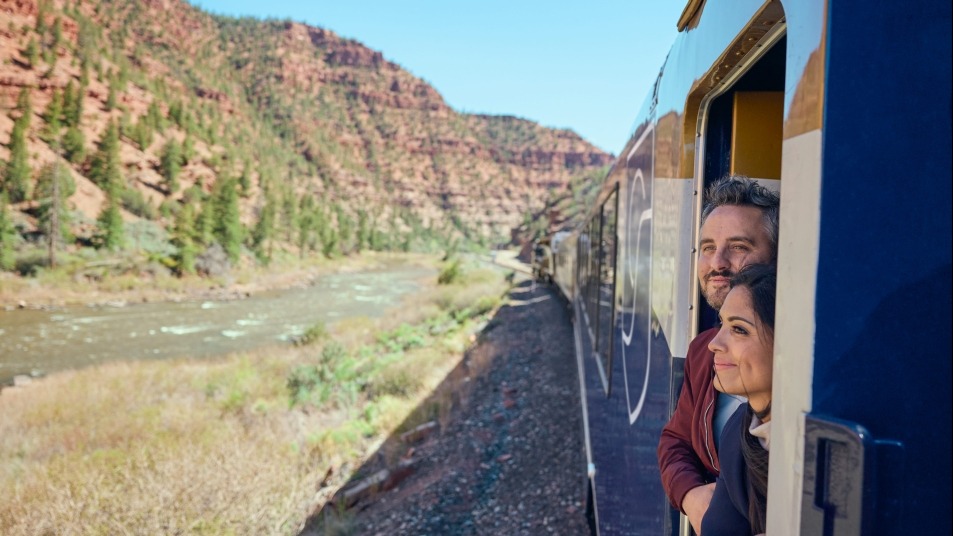 Two guests in the outdoor viewing area on Canyon Spirit