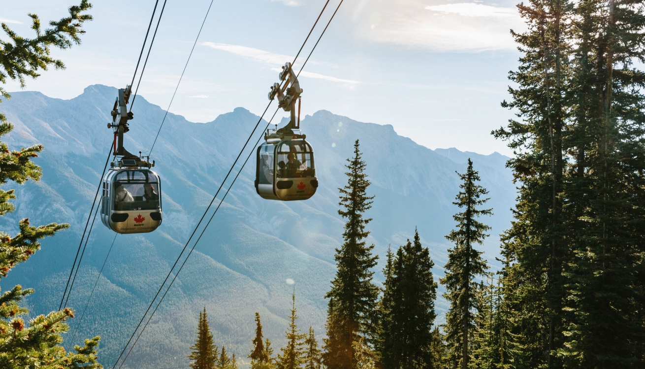2 gondola cars ascend Sulphur Mountain