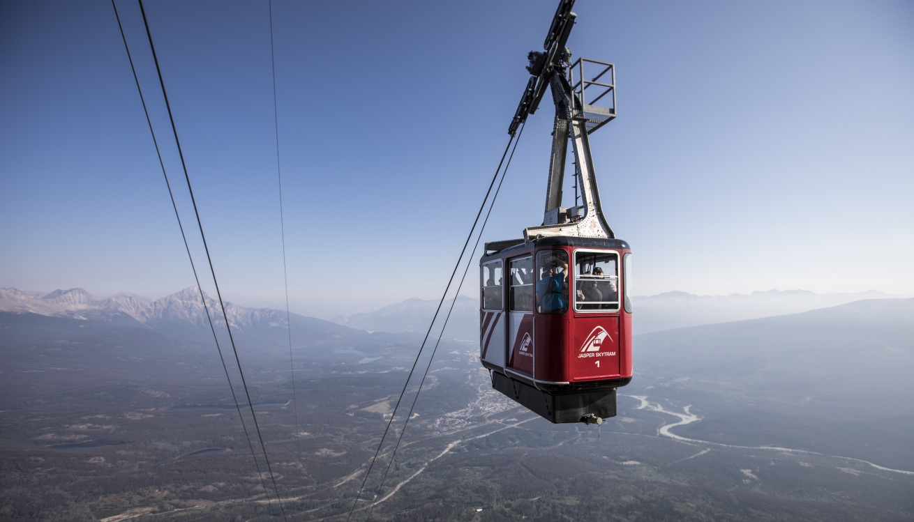 gondola cars ascend mountain