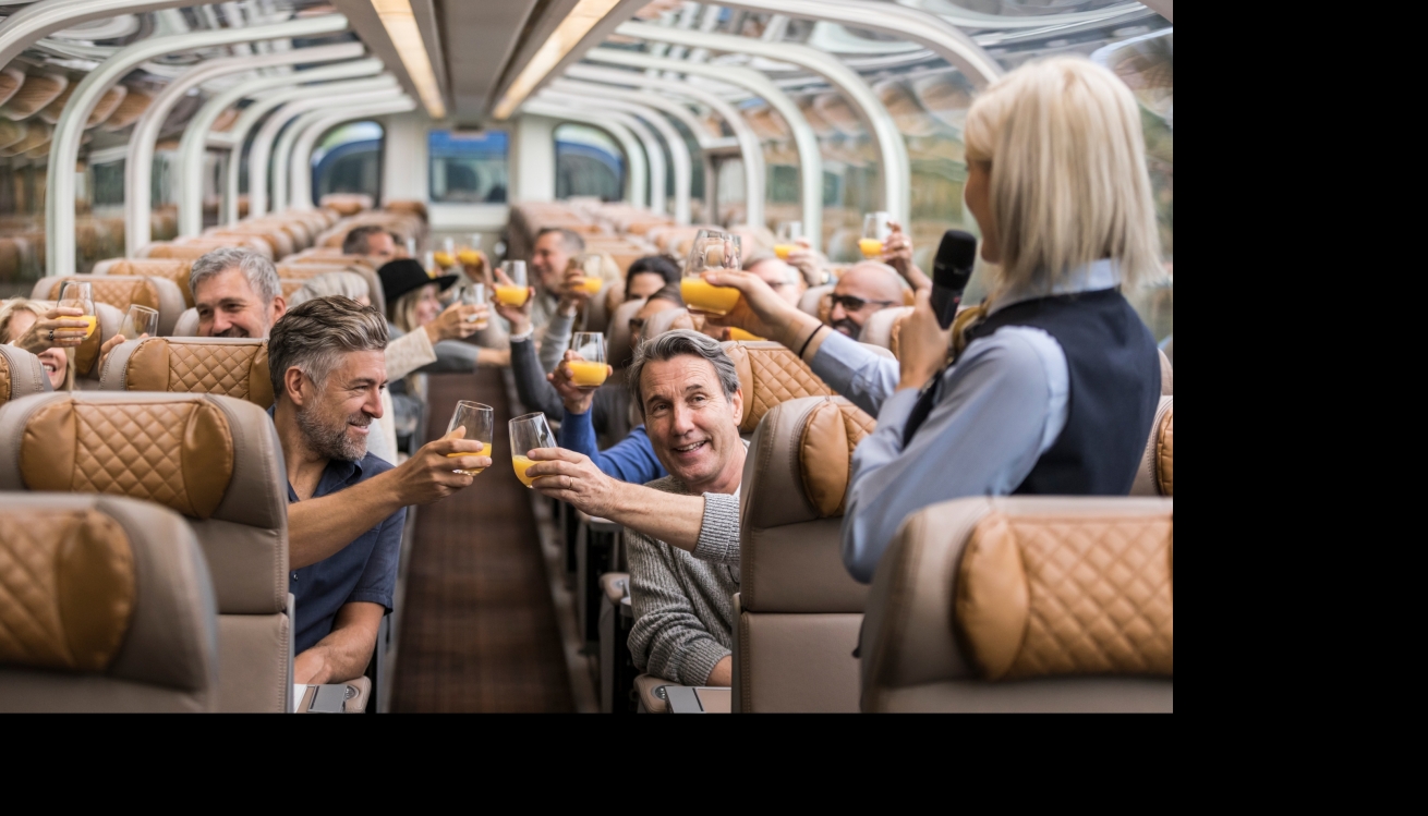 Guests celebrating on a Rocky Mountaineer Goldleaf train.