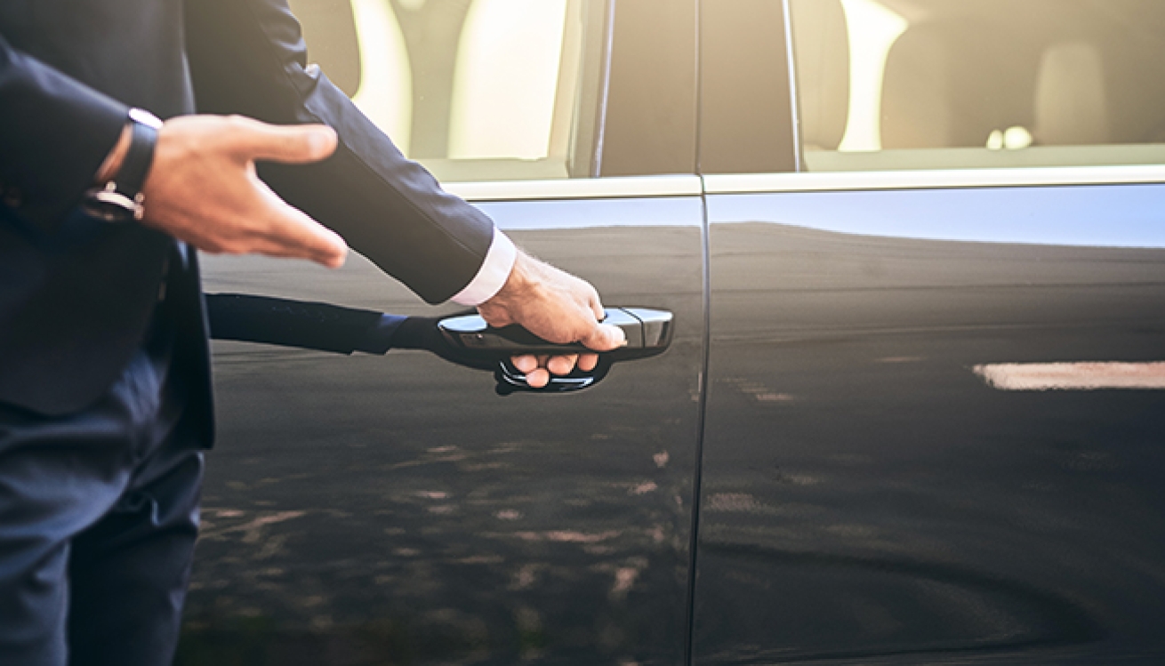 man-standing-in-front-of-black-sedan-about-to-open-door