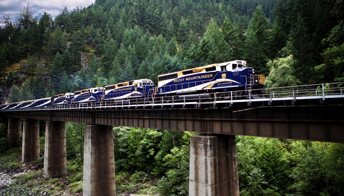 rocky mountaineer train crosses bridge hear hell's gate