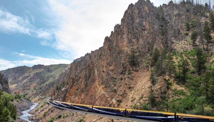 Rocky Mountaineer train travelling through Byers Canyon alongside the Colorado River