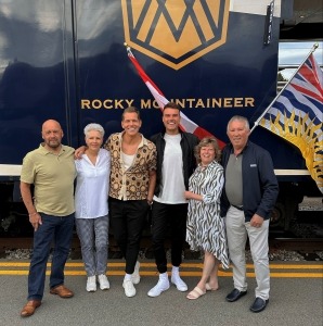 Family standing in front of the Rocky Mountaineer train